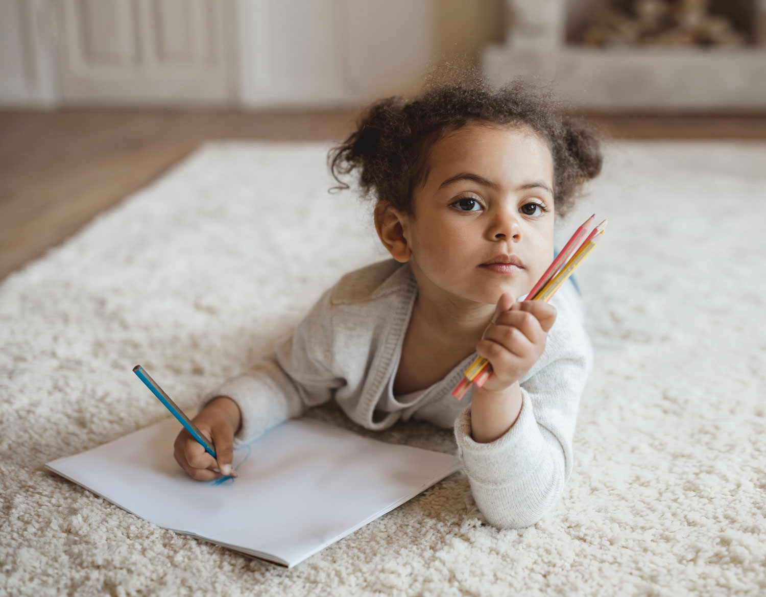little girl writing on rug