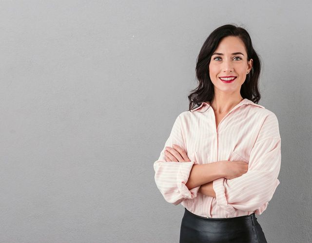 professional woman standing with crossed arms