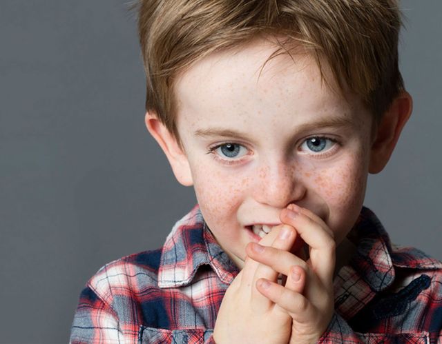 boy with hands on face