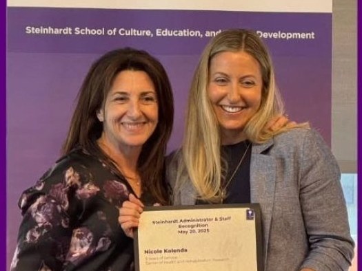 Nicole holding her NYU Steinhardt Administrator and Staff Recognition certificate