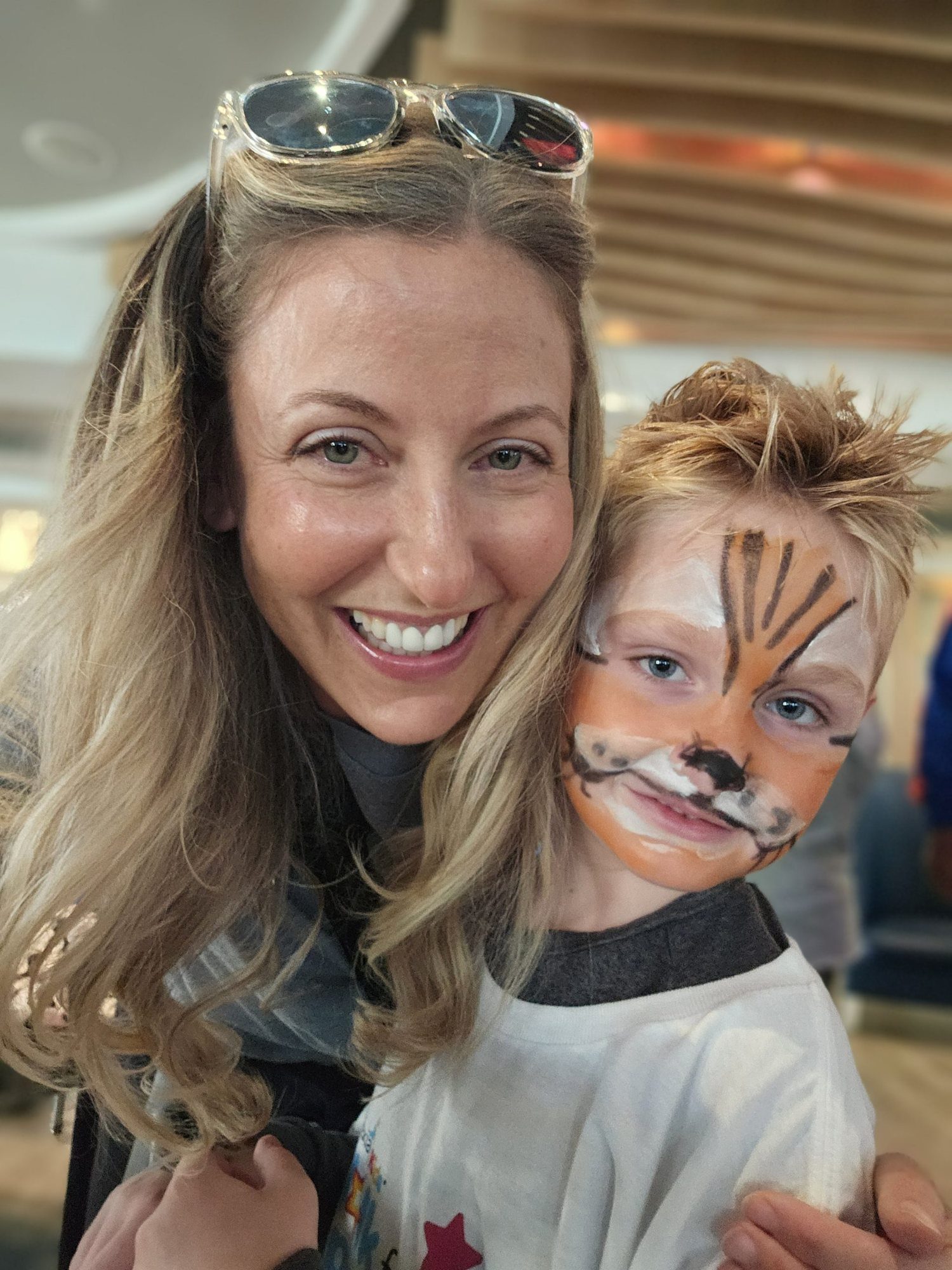 Nicole with a little boy whose face is painted like a tiger