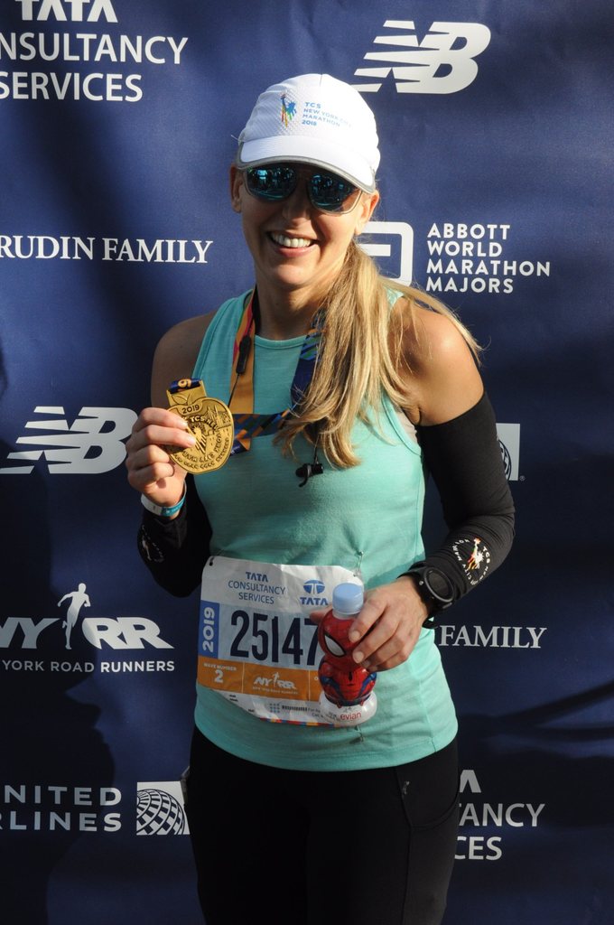 Nicole with her 2019 NYC Marathon finisher medal