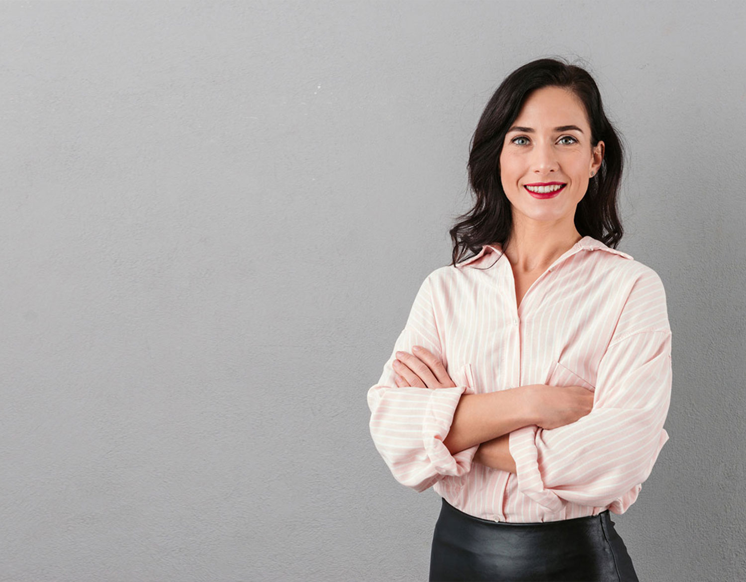 professional woman standing with crossed arms