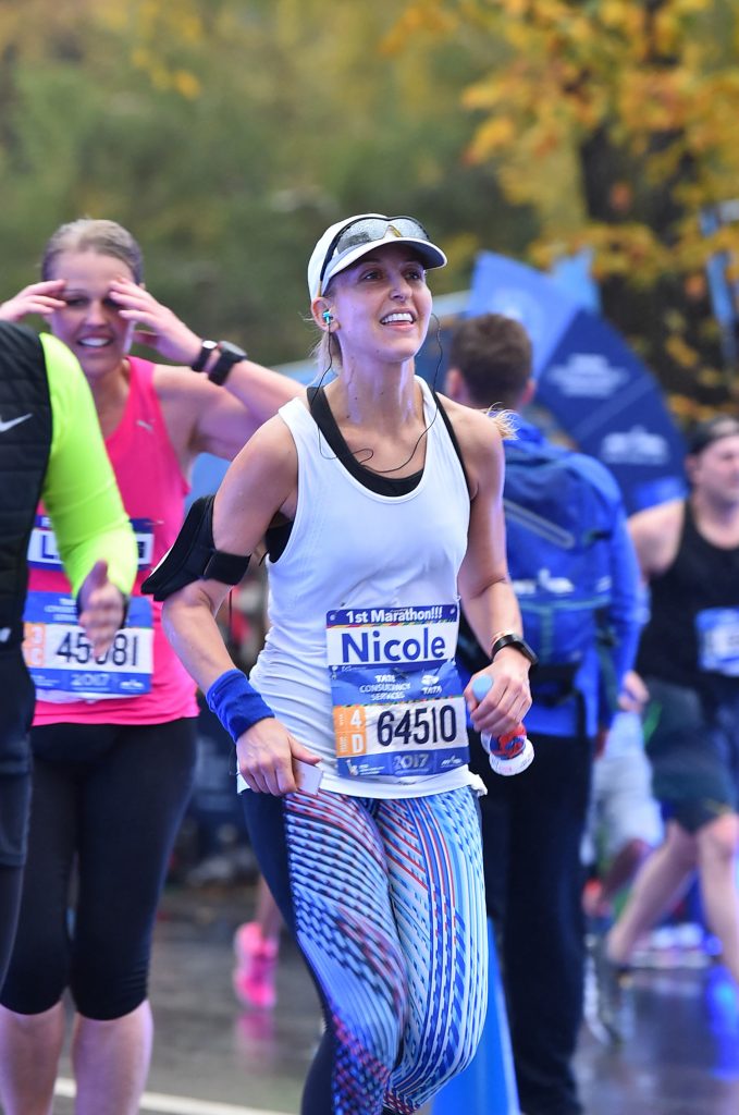 Nicole smiling as she runs the 2017 New York City Marathon