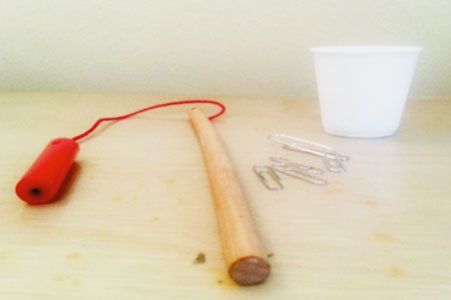 paper clips, cup, magnet fishing pole