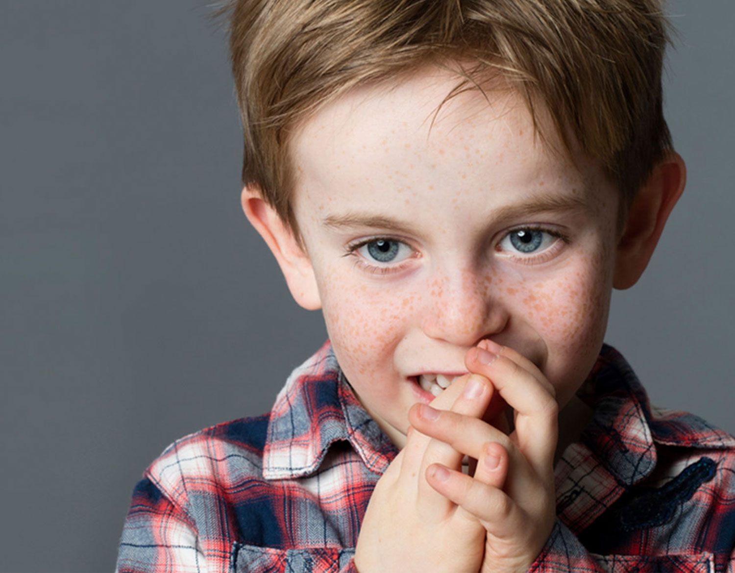boy with hands on face